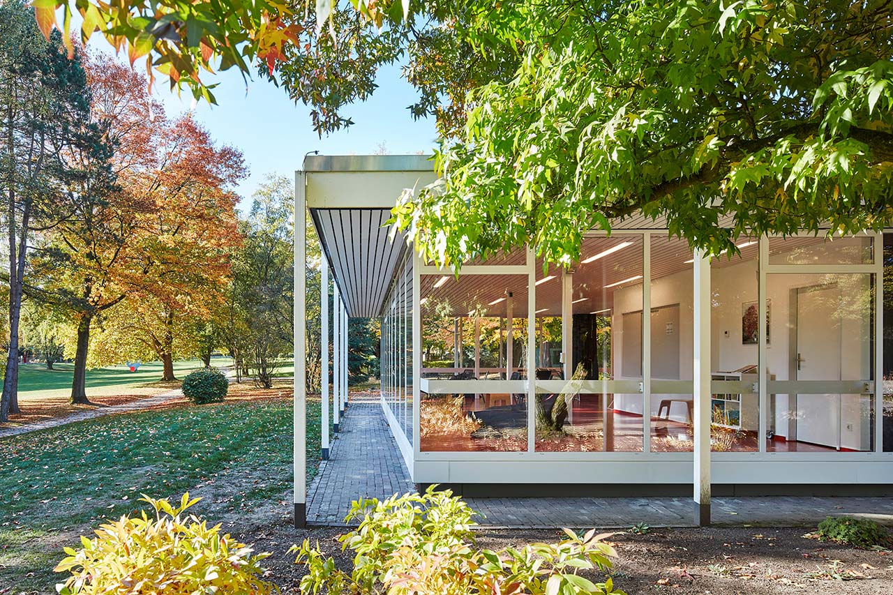 Lesepavillon der GRUGA in Essen zwischen Bäumen und Sträuchern.
