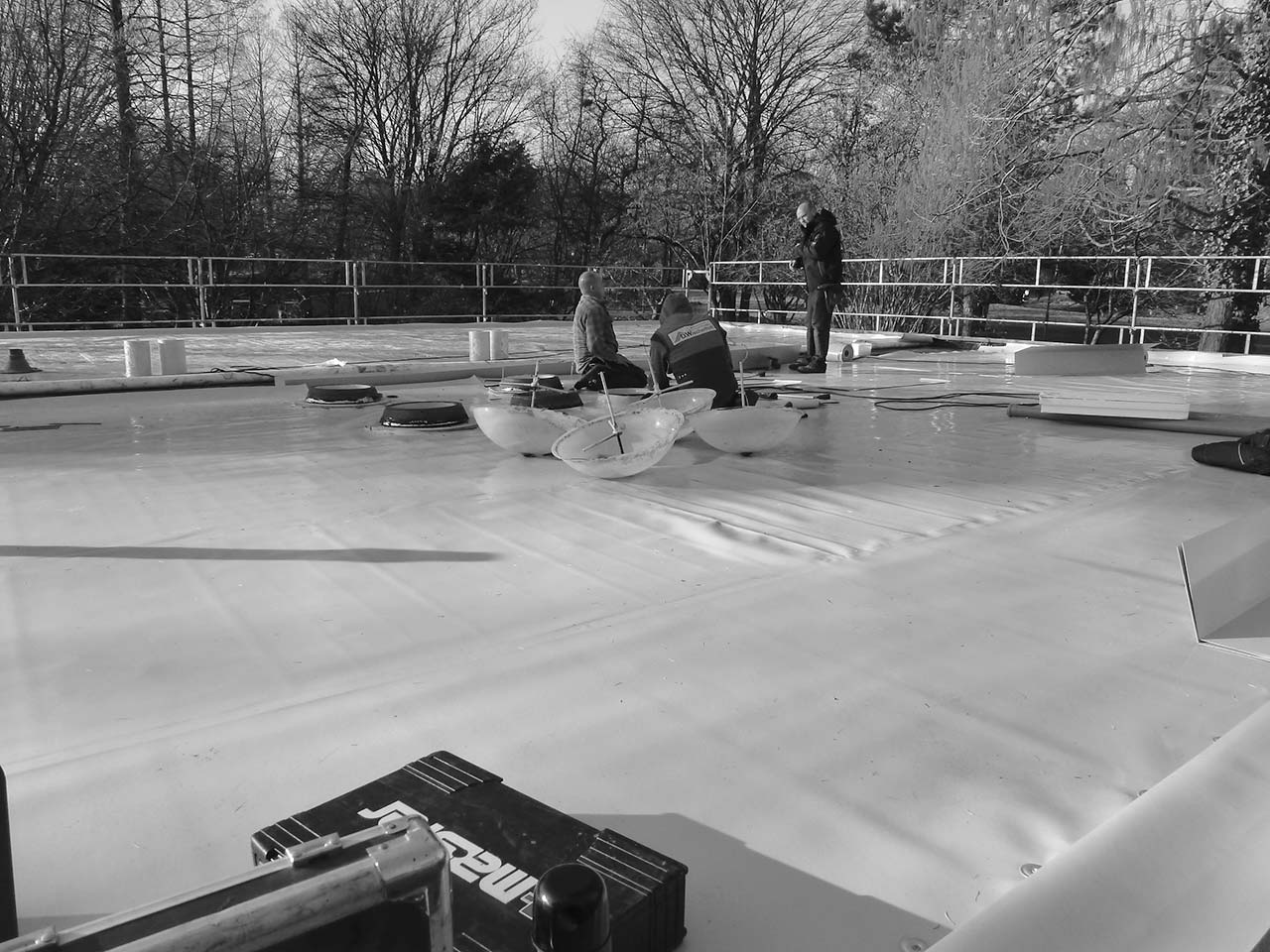 Bauarbeiter bei Arbeiten auf einer Dachfläche.